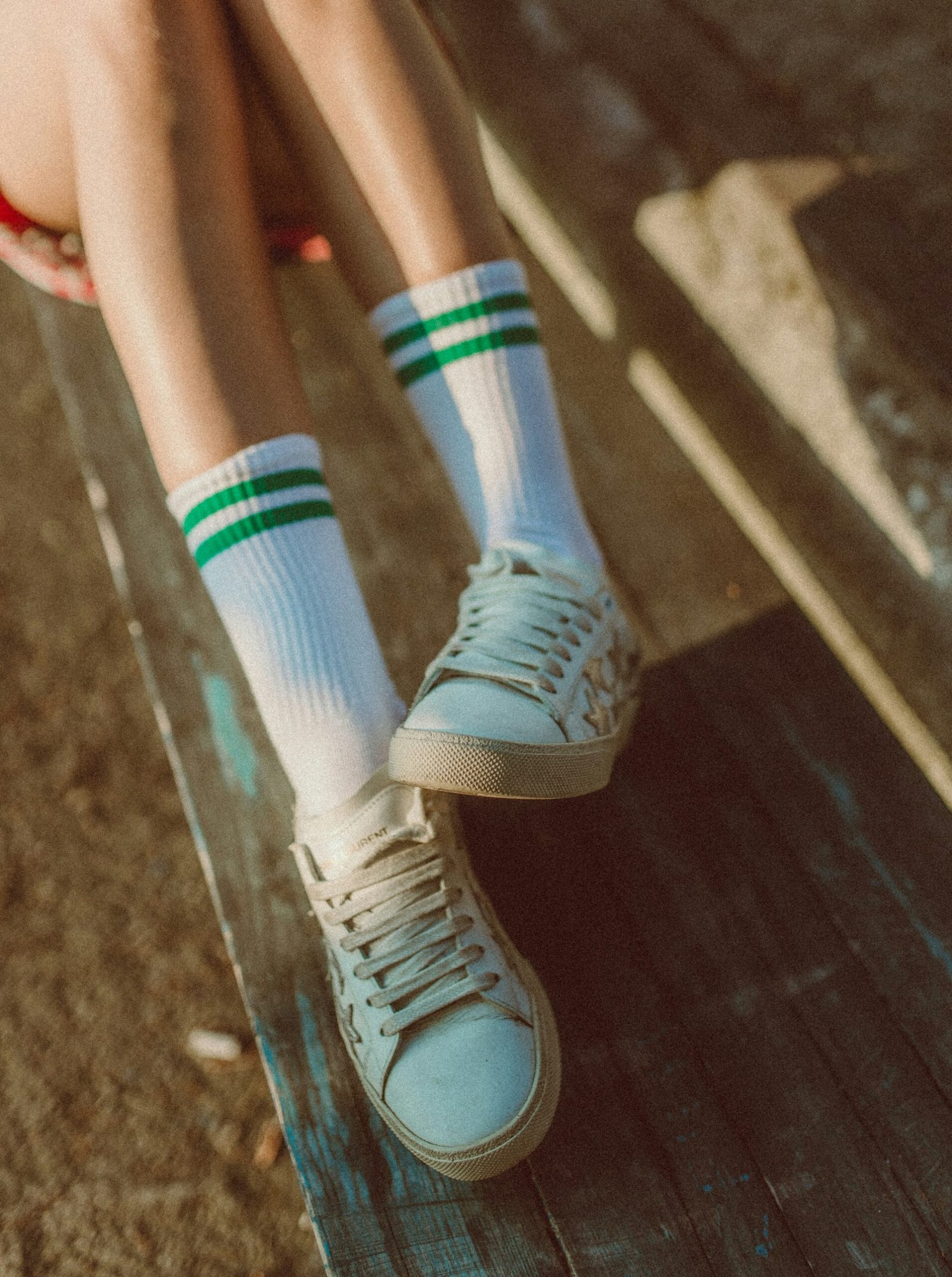 White sneakers with striped socks outdoors