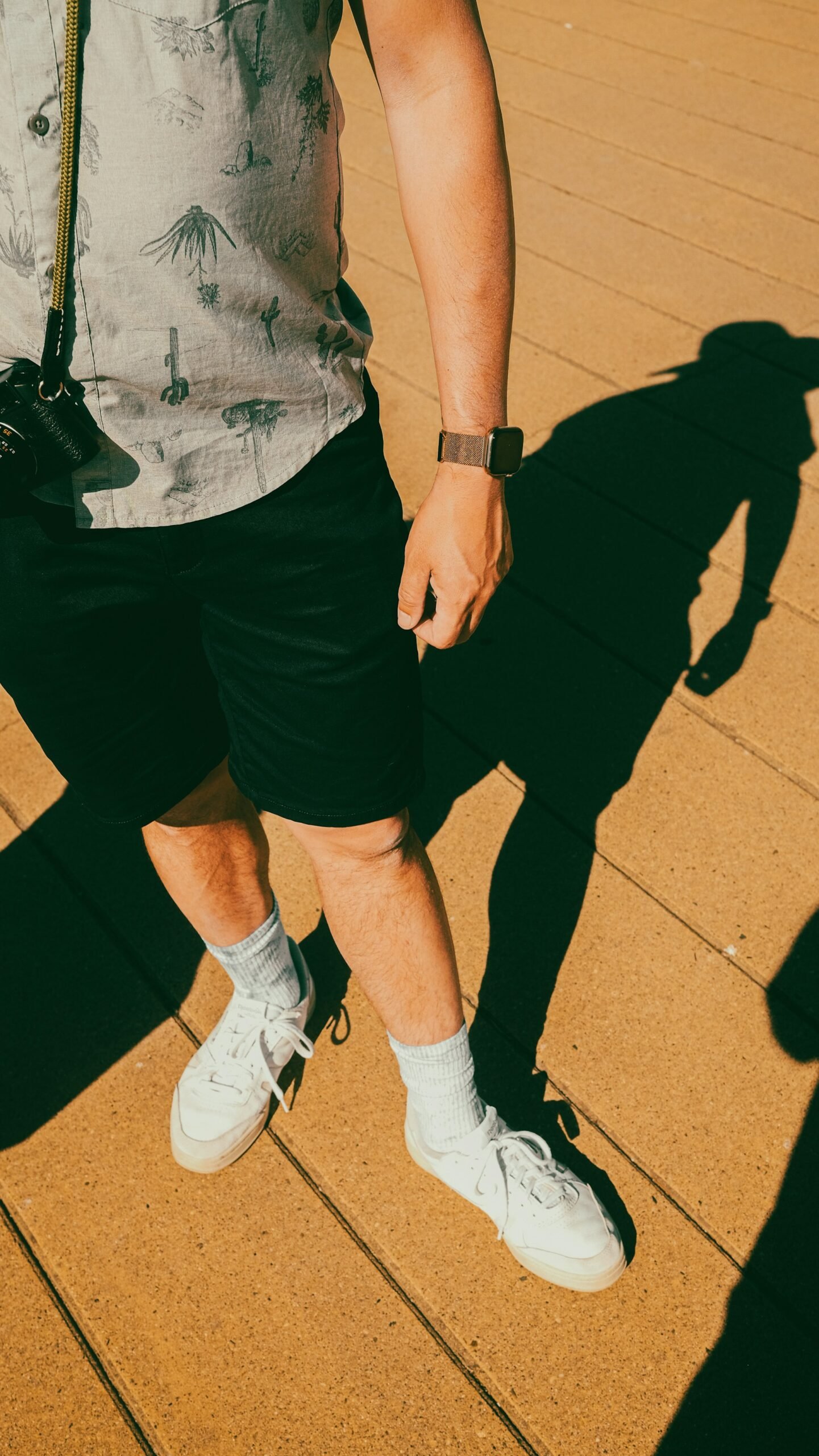 Two people in shorts wearing white sneakers