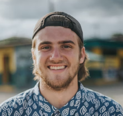 Smiling man in cap outdoors